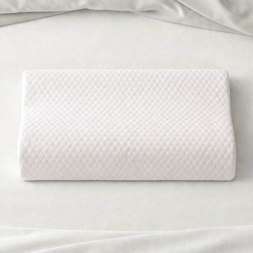 White pillow on a white bed